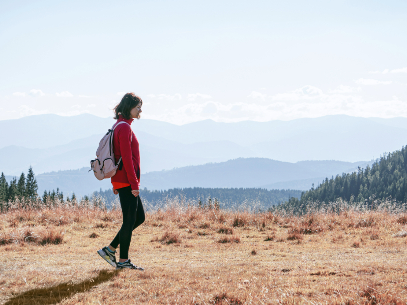 woman walking outdoors representing how much exercise do you really need