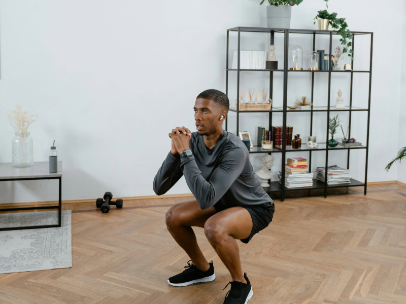 Beginner practicing bodyweight squats as part of a strength training routine