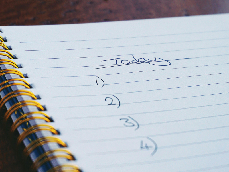Simple beginner strength training plan written in a notebook