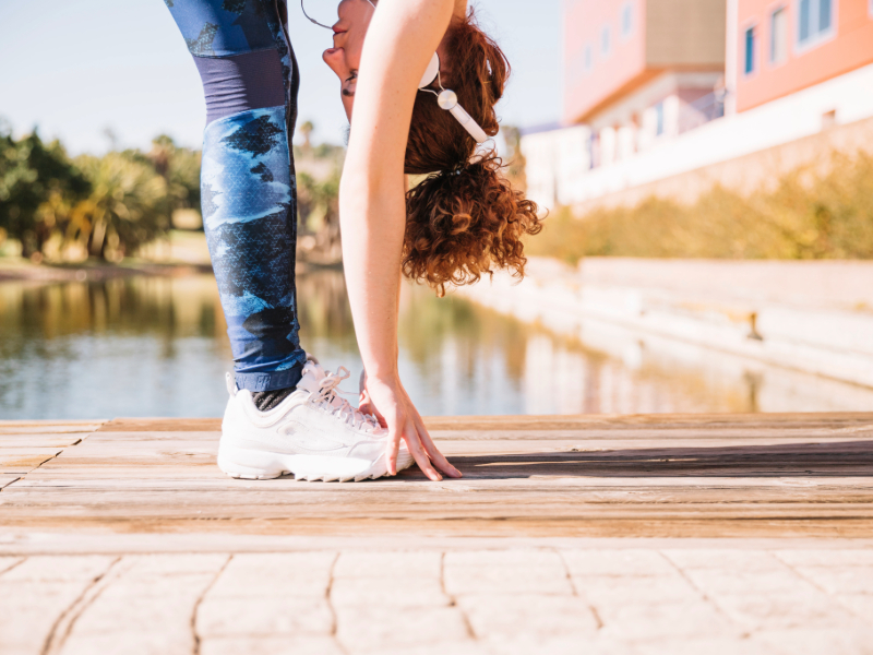Person stretching legs before a light outdoor exercise