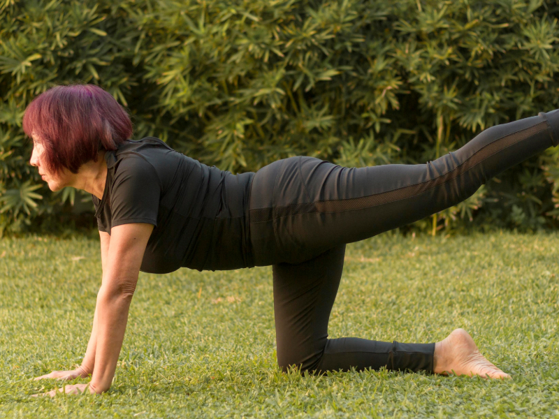 Beginner practicing bird-dog exercise to strengthen core and improve balance.