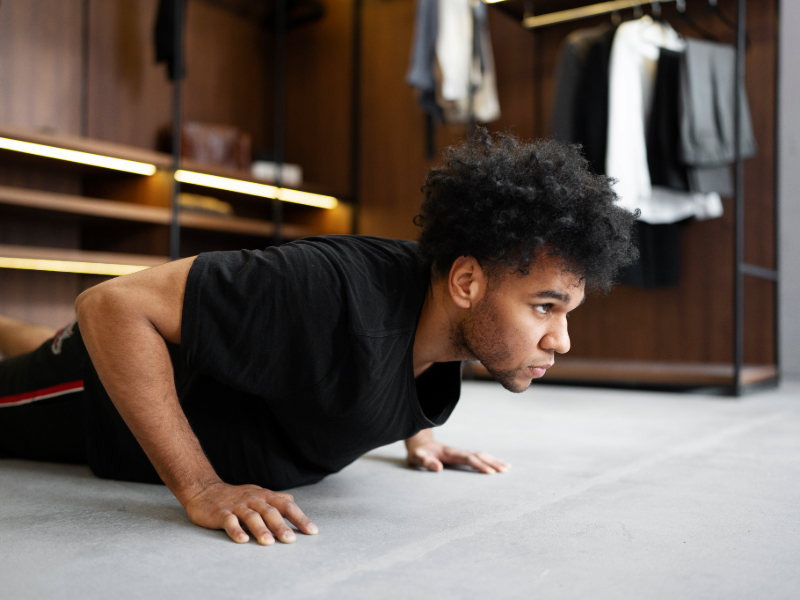 Man doing modified bodyweight push-ups on a mat, ideal for beginners