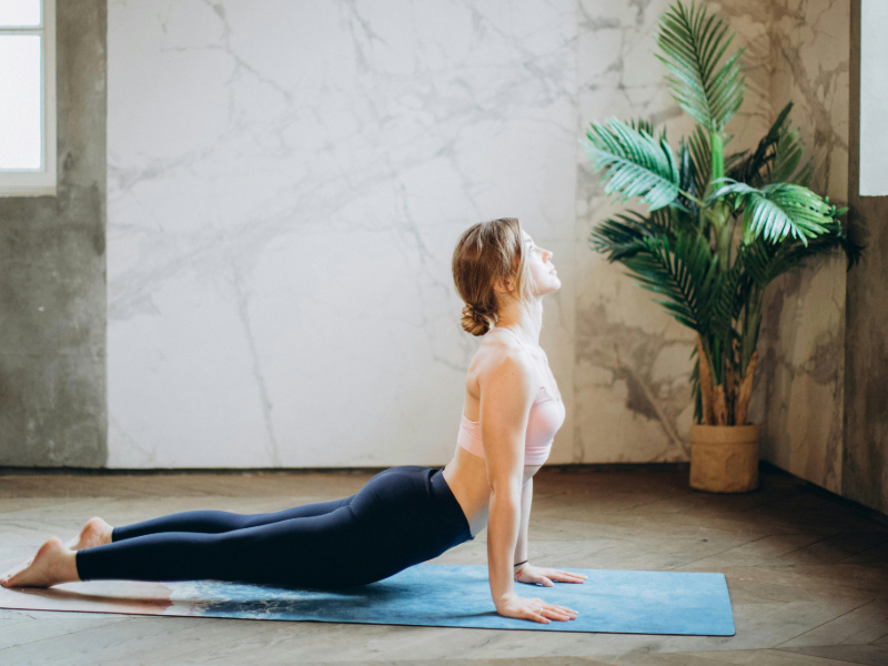 Woman doing light stretching as part of a consistent workout routine for beginners