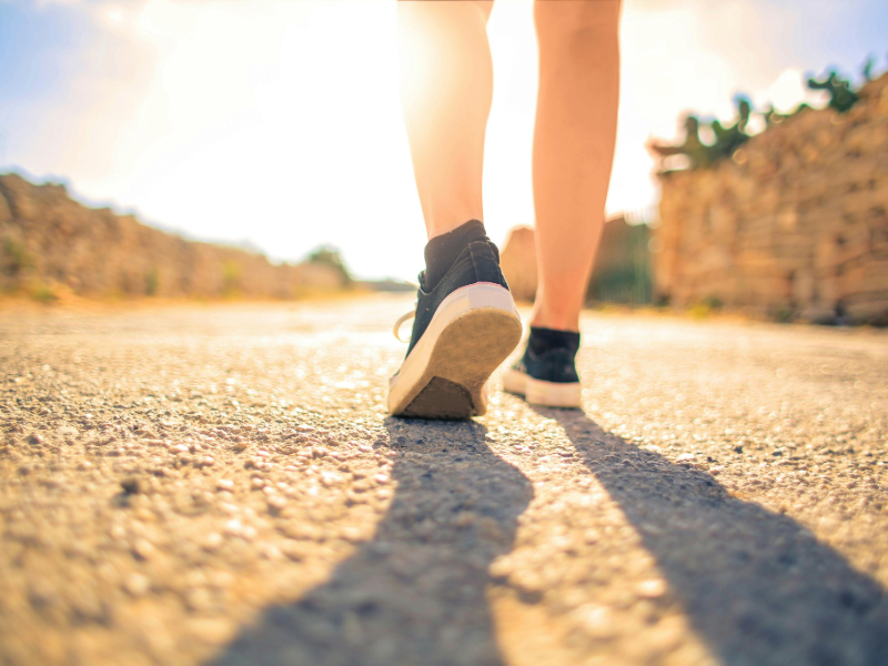 Person enjoying a morning walk in the park
