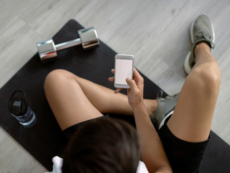 Woman following a beginner HIIT workout video on tablet