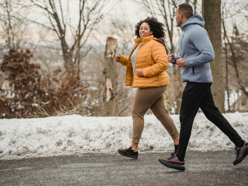 Middle-aged adult walking outdoors in workout clothes